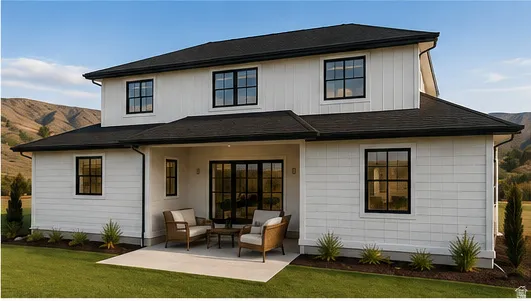 White-paneled exterior with black-framed windows, black shingle roof, and an exterior patio