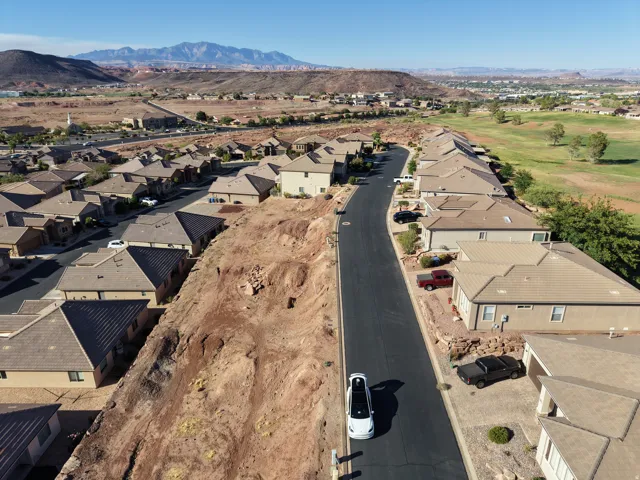 Residential development featuring a paved street and single-story properties