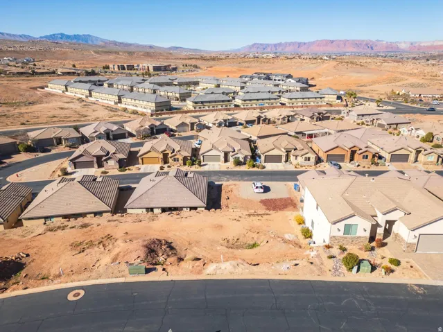 Expansive desert landscape featuring numerous residential properties and mountainous terrain