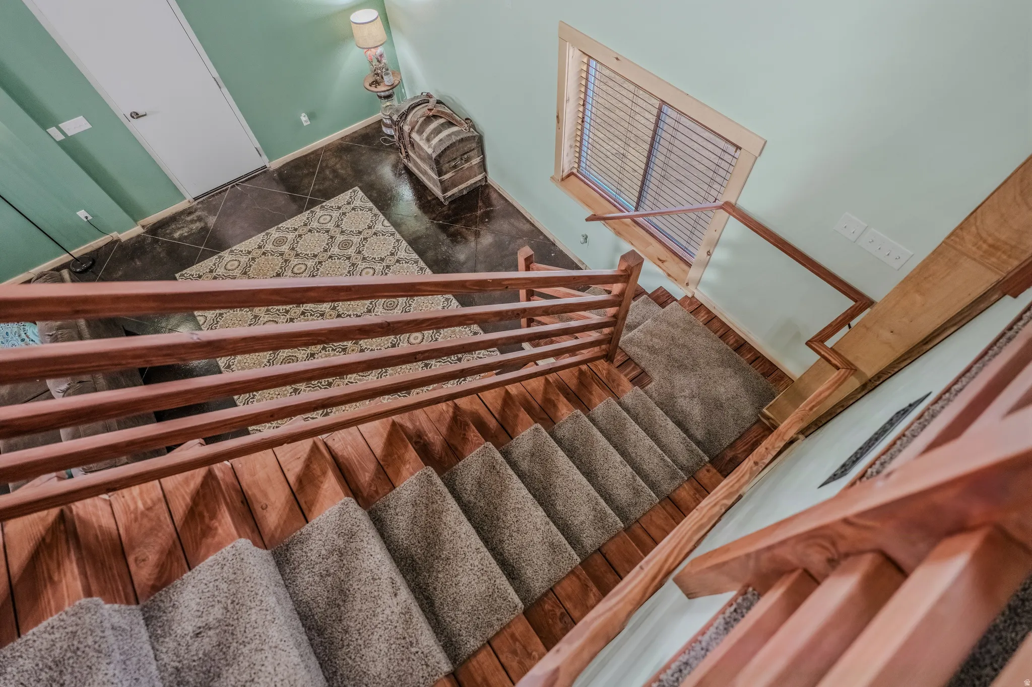 Wood-finish staircase with carpeted treads