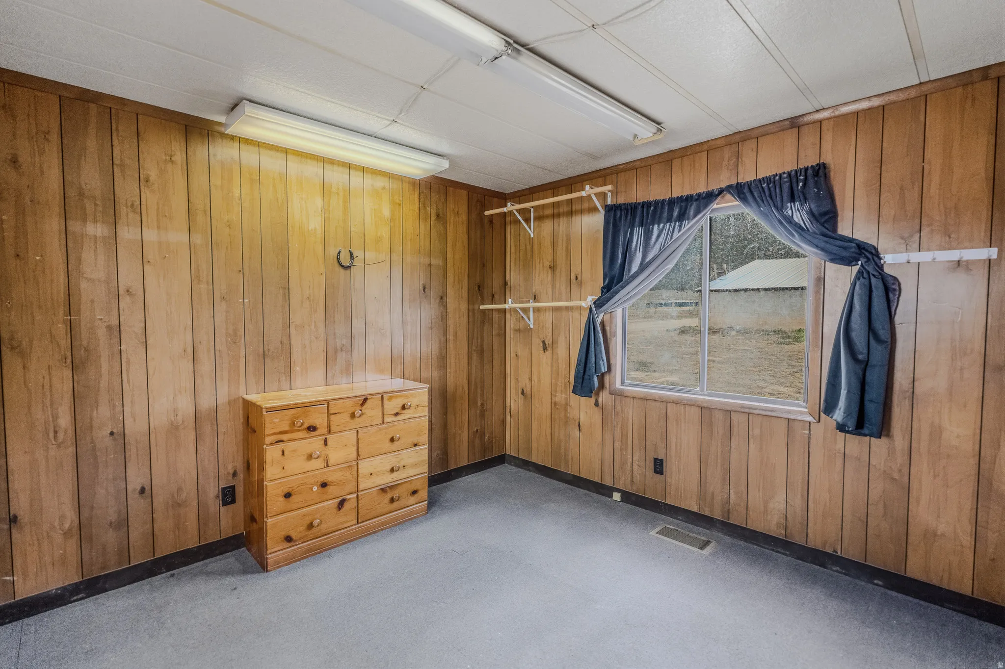 Wood-paneled walls and a window offering natural illumination