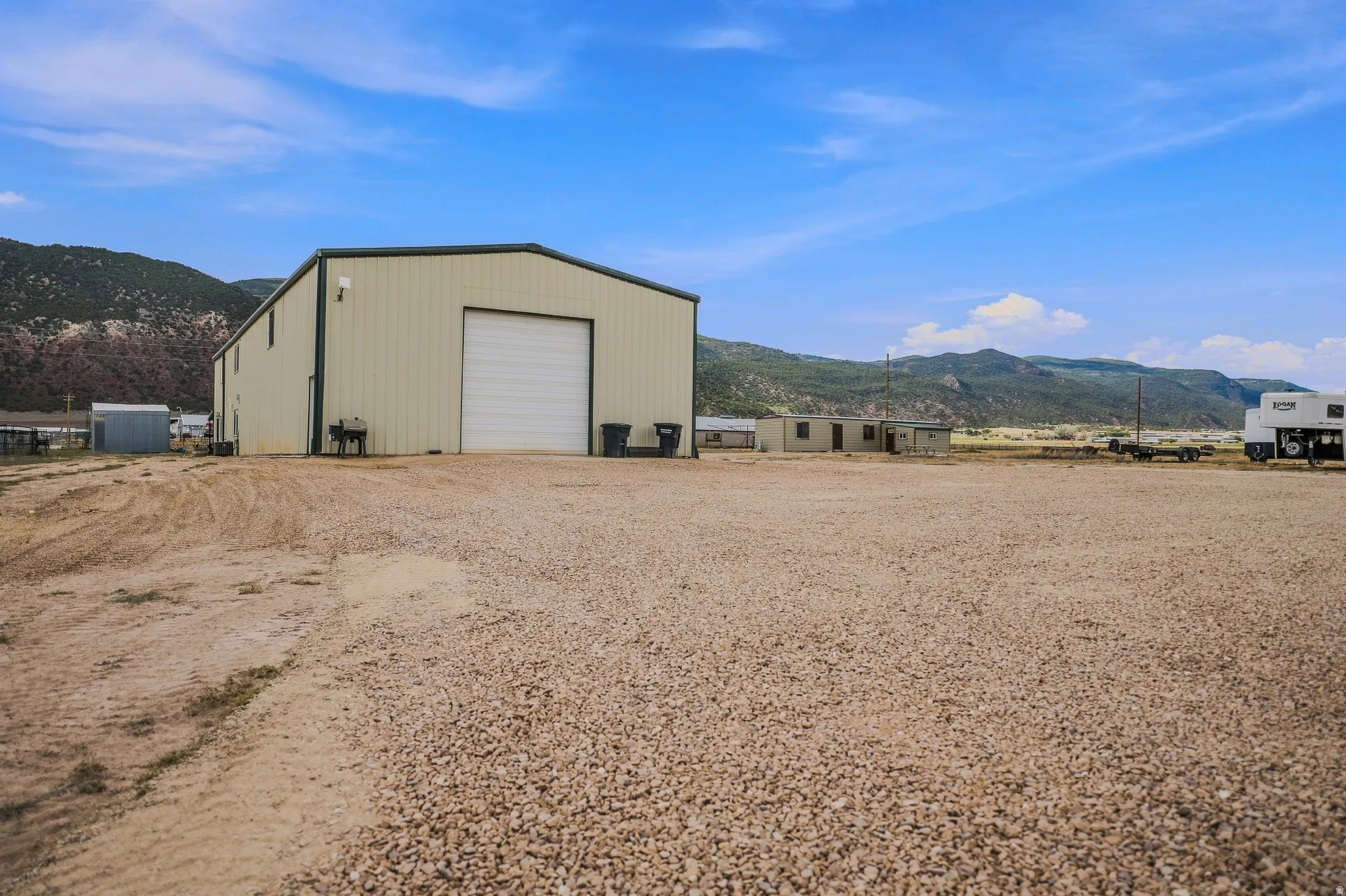 Large metal building featuring a roll-up door