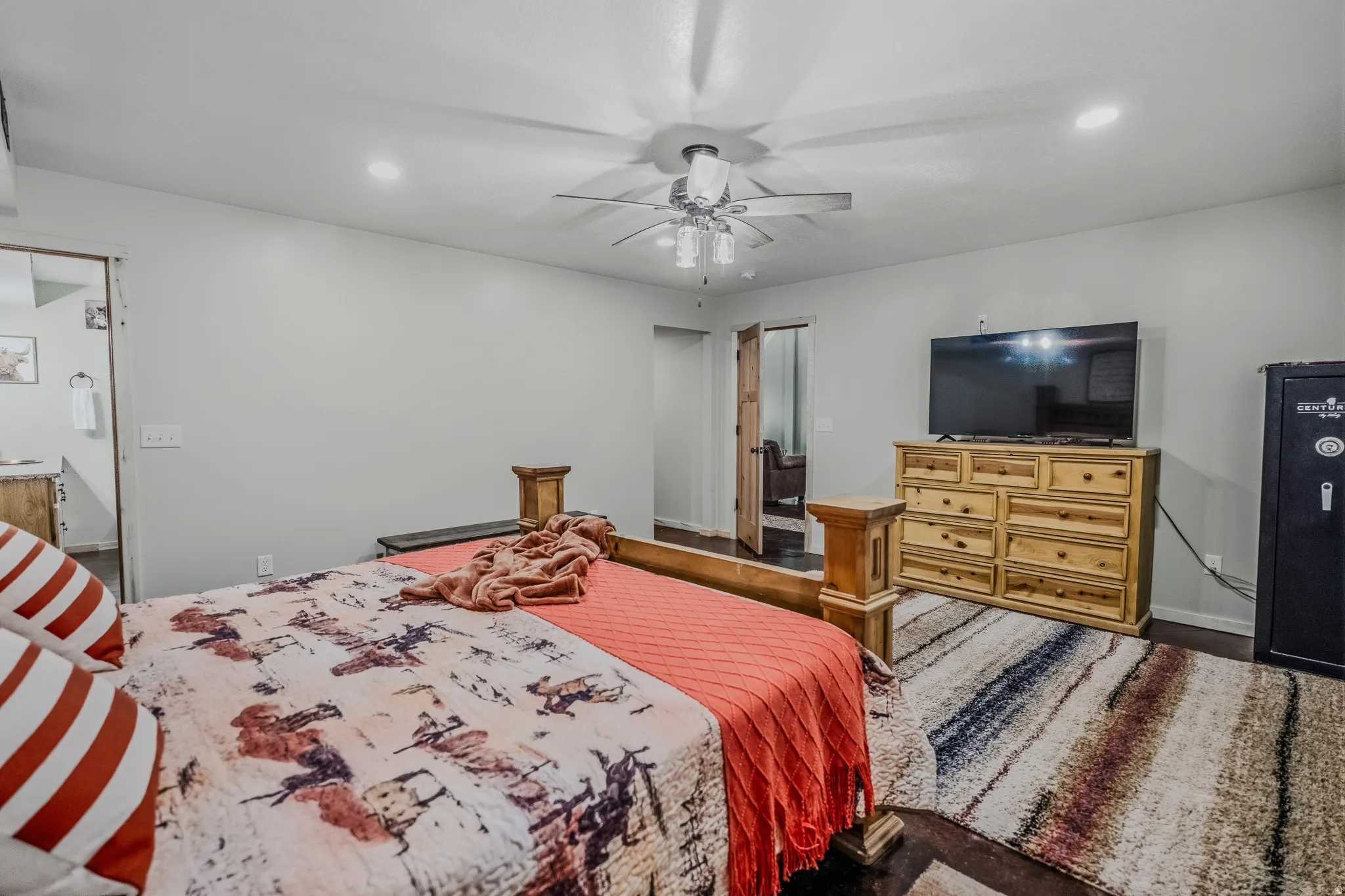 Recessed lighting, ceiling fan with light fixture, wood-finish flooring, light grey wall paint