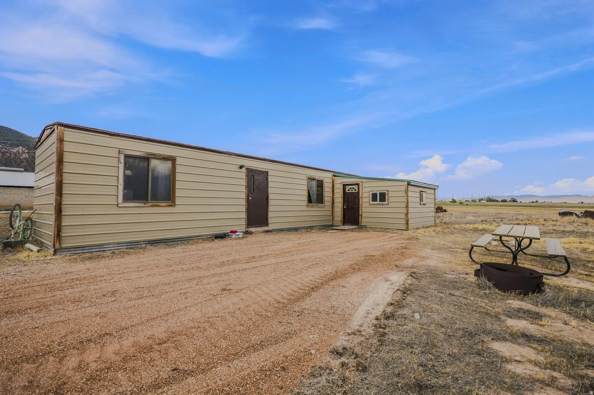 Metal-sided structure with multiple window openings and exterior doors