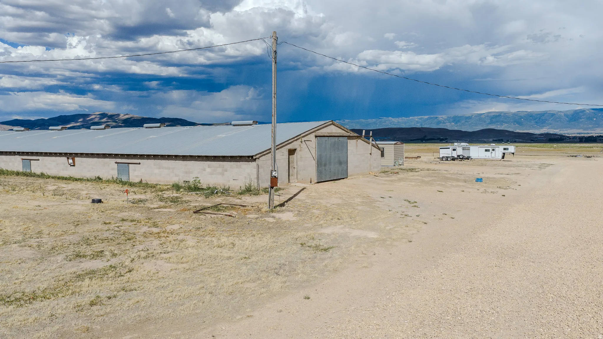 Long, single-story structure with a metal roof and concrete block walls