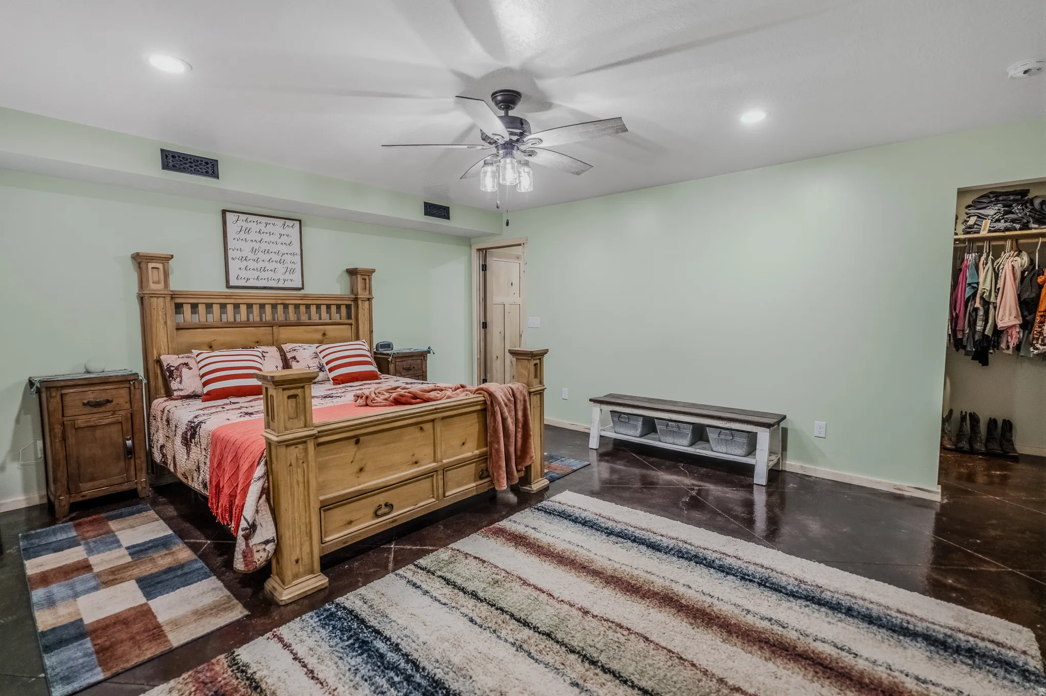 Spacious room featuring dark-toned flooring, recessed ceiling lighting, a ceiling fan, and an open closet