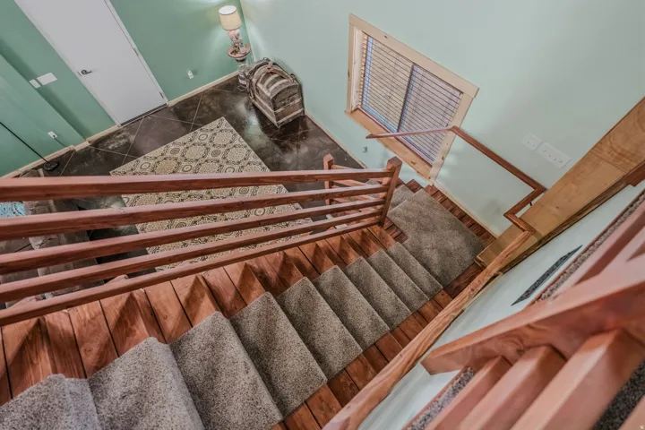 Wood-finish staircase with carpeted treads