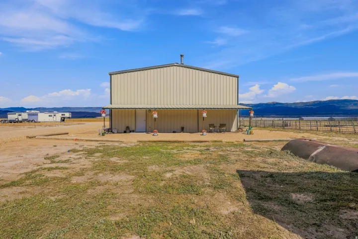 Metal-sided outbuilding with an extended covered porch