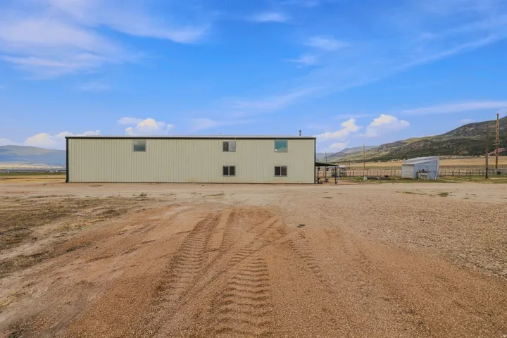 Large beige metal-sided structure with multiple windows
