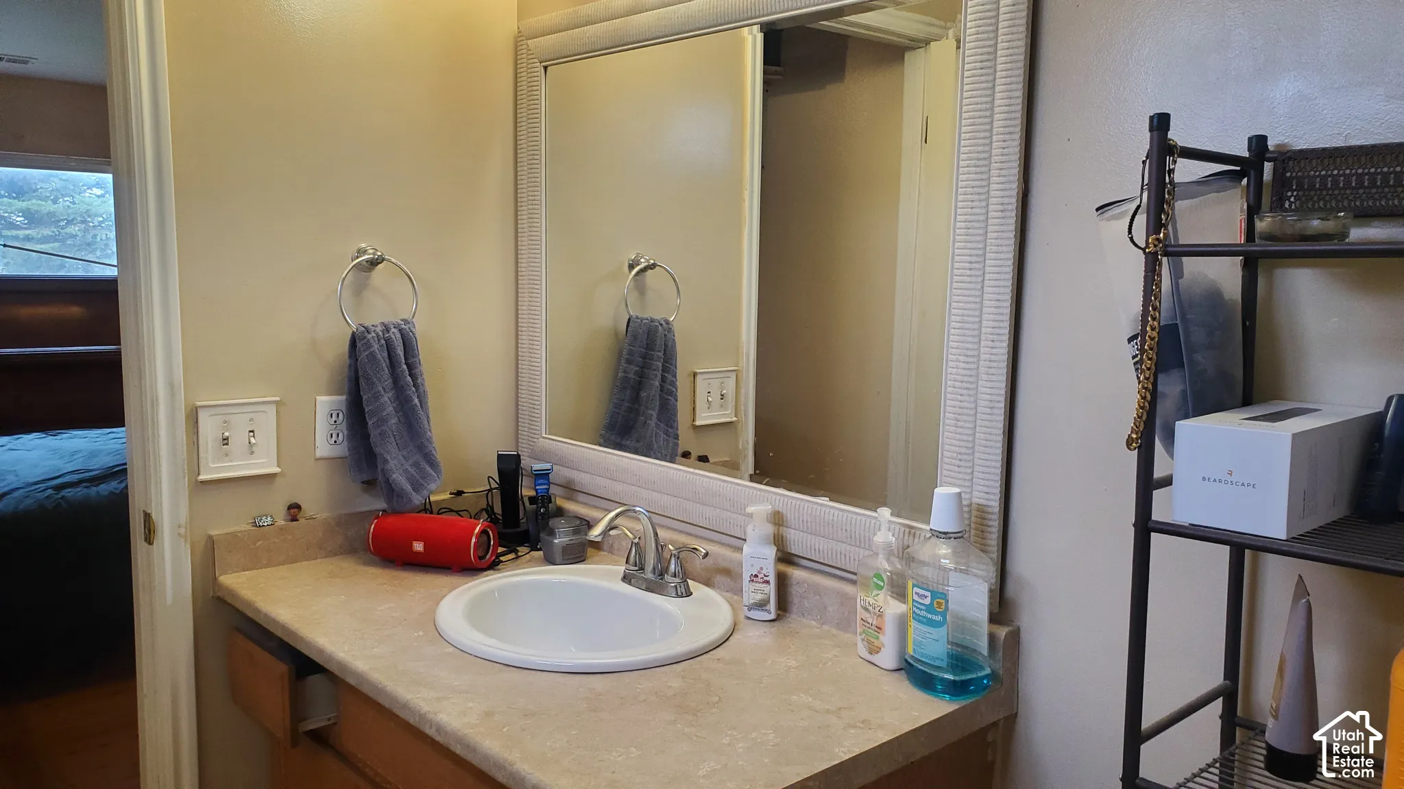 Bathroom vanity with a light-colored countertop and integrated sink