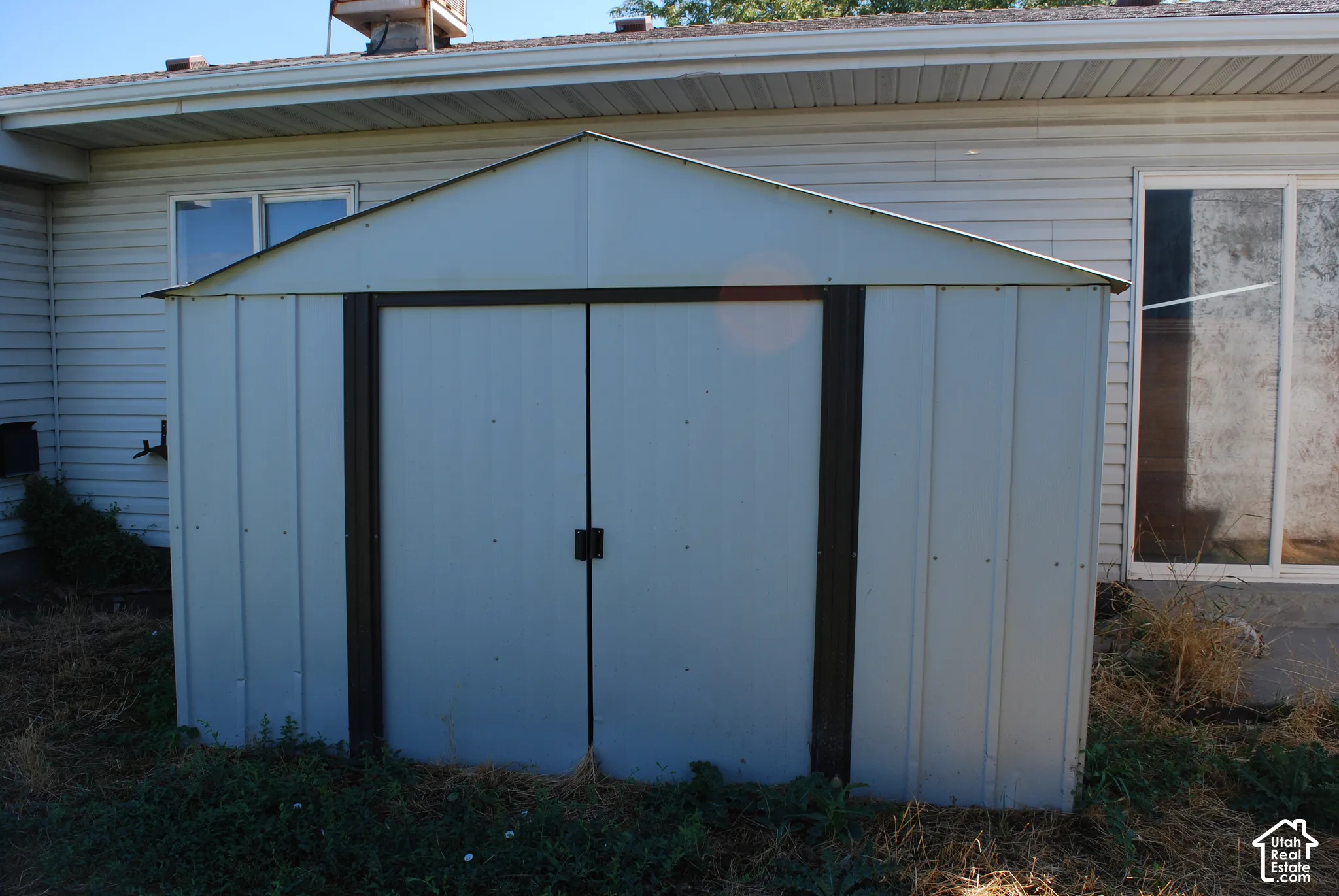 Utility shed with a peaked roof and double doors