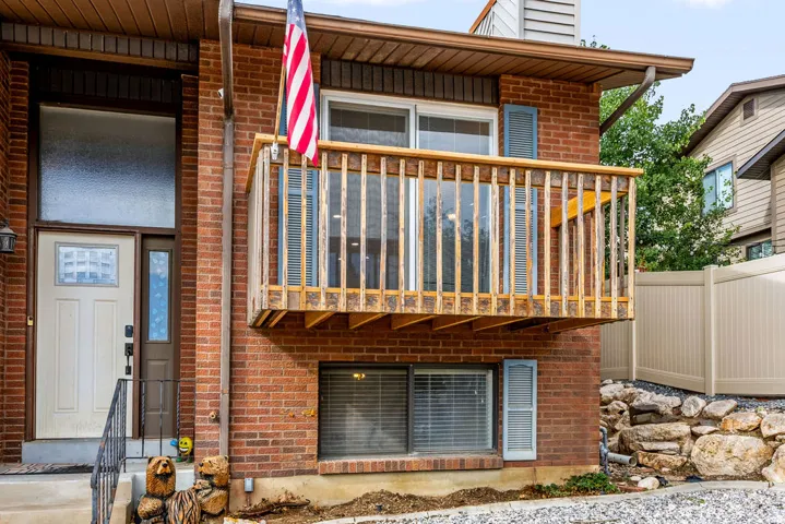 Brick facade with an elevated wooden balcony