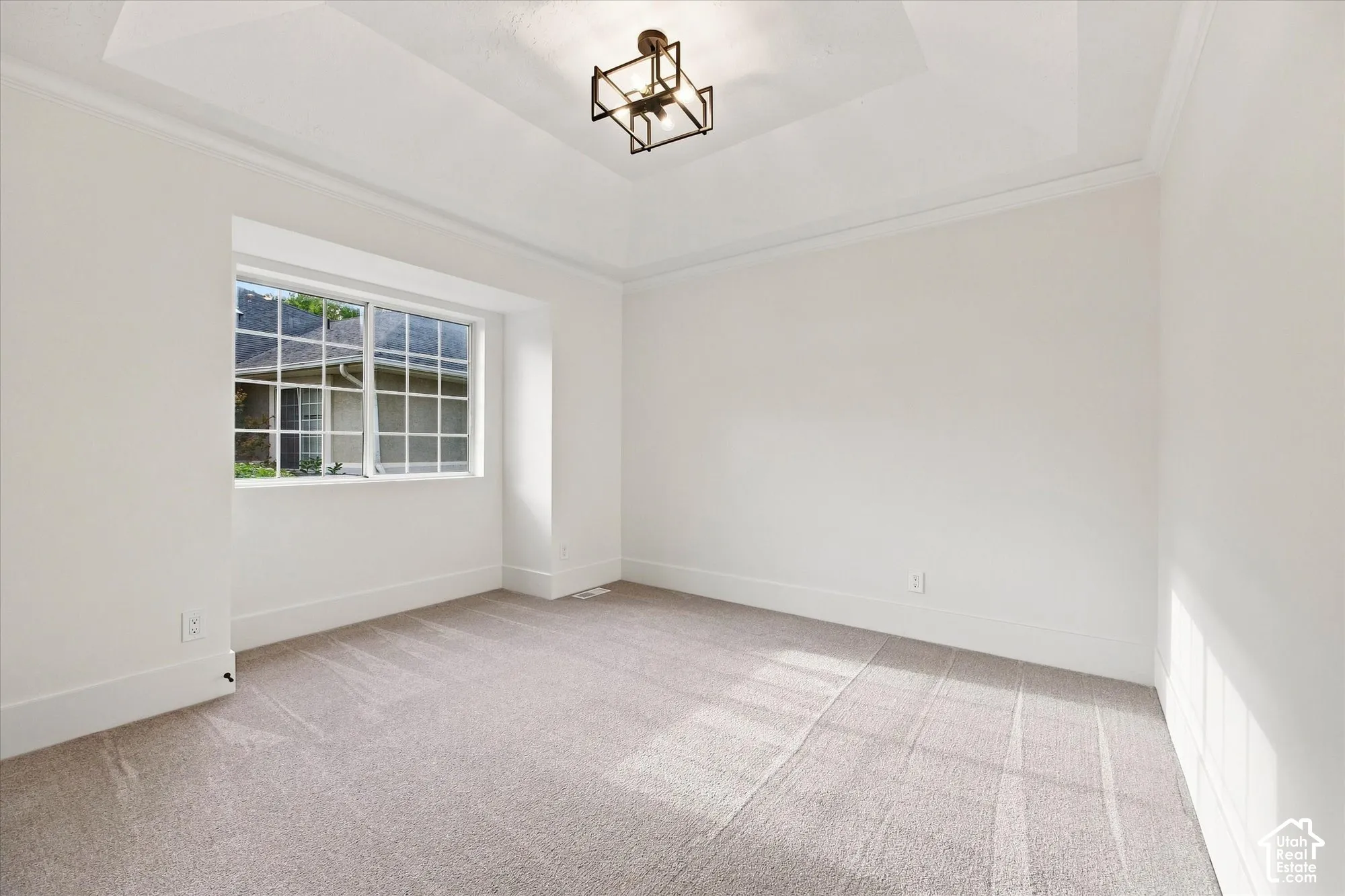Recessed tray ceiling with crown molding and an architectural light fixture