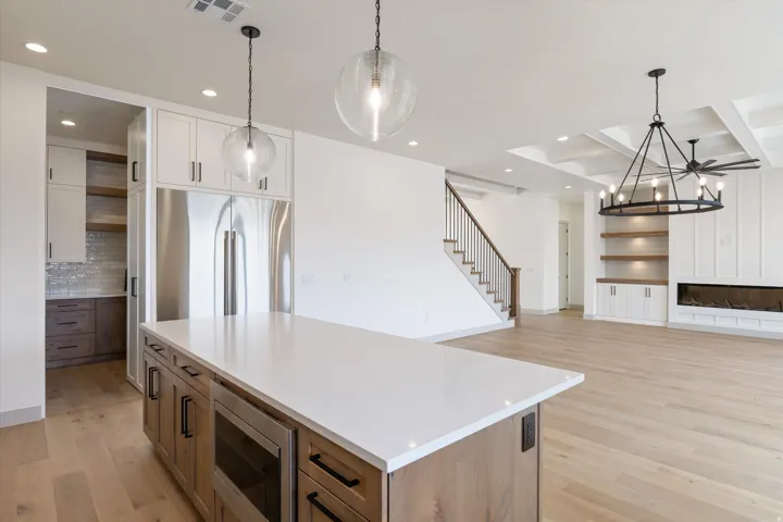 Kitchen island with a white countertop and wood-finish cabinetry