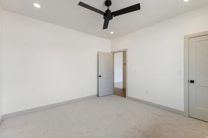 Recessed lighting, ceiling fan with matte black finish, light gray carpeting, and light gray interior doors with matte black hardware