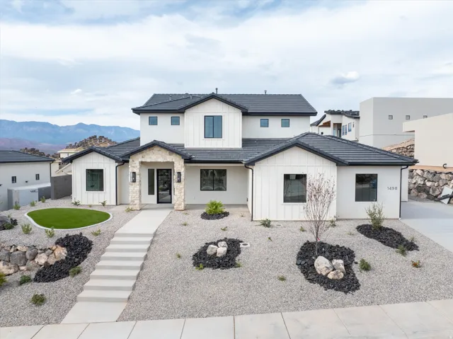 Modern two-story residence featuring a black tile roof and white board-and-batten siding