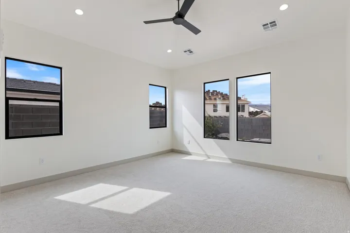 Recessed lighting, ceiling fan, multiple windows, carpet flooring, and neutral wall finishes