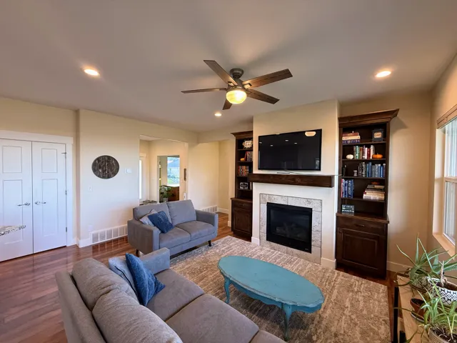 Hardwood flooring, recessed lighting, and a ceiling fan with integrated lighting