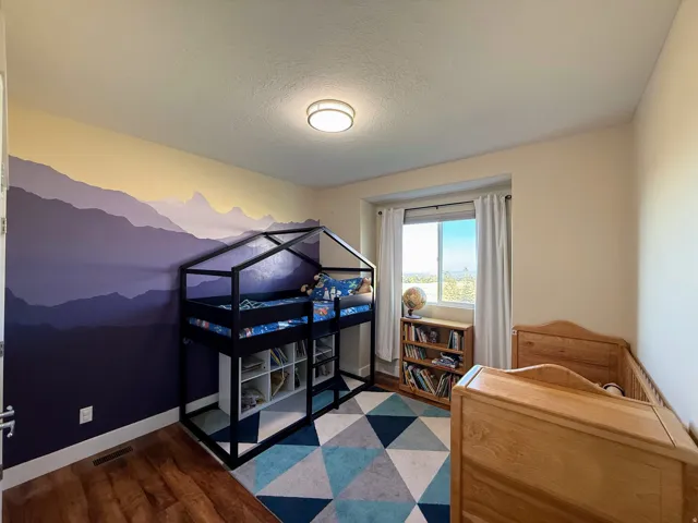 Wood-finish flooring with a multi-tone wall mural and natural light