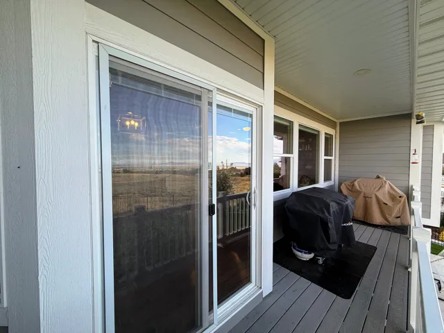 Covered outdoor patio with composite decking and sliding glass door access