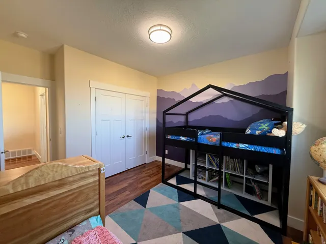 Wood-finish flooring, recessed lighting, double-door closet, painted accent wall