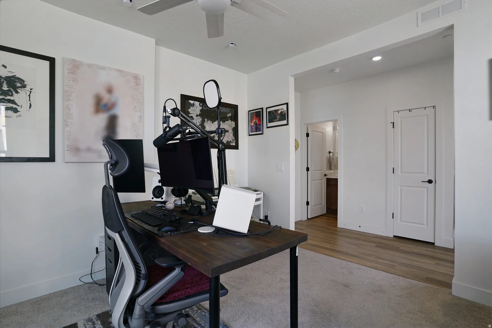 Recessed lighting, ceiling fan, wood-finish flooring, white paneled doors, and an open entryway