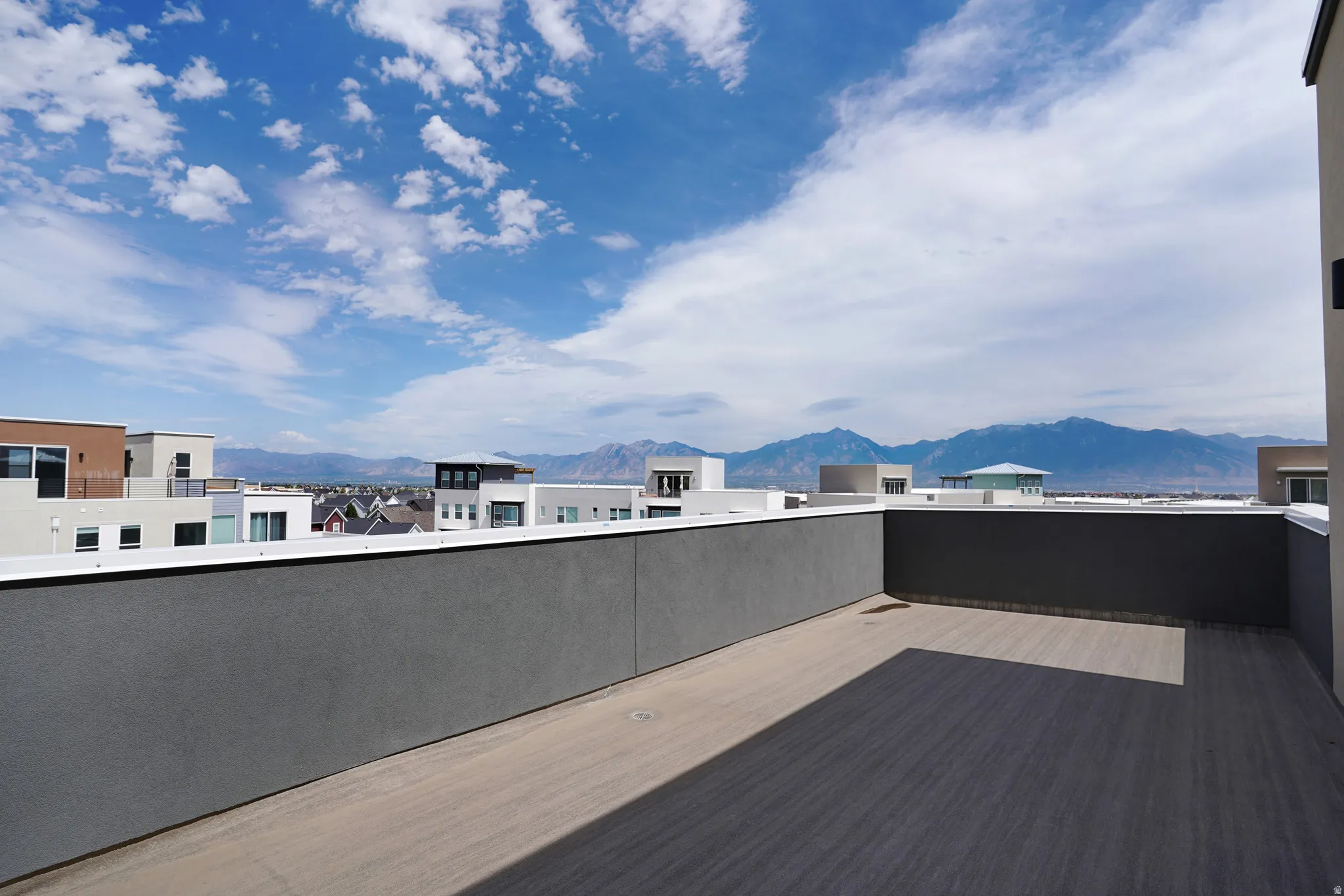 Expansive rooftop deck with composite decking and low-profile perimeter walls