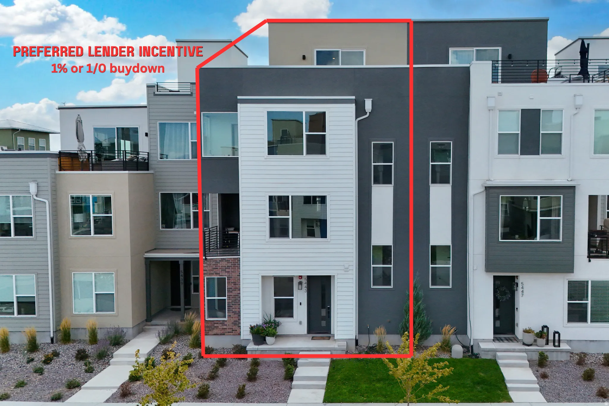 Modern townhome with multi-level windows, a recessed entry, and vertical siding accents