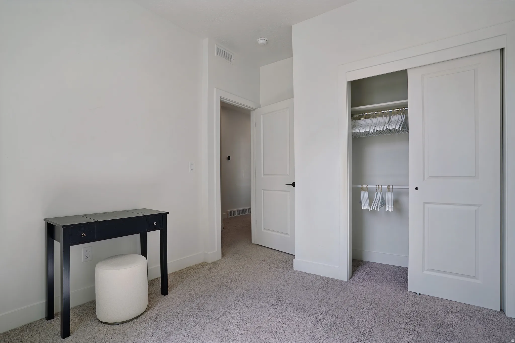 Plush carpeting and a built-in closet with sliding doors