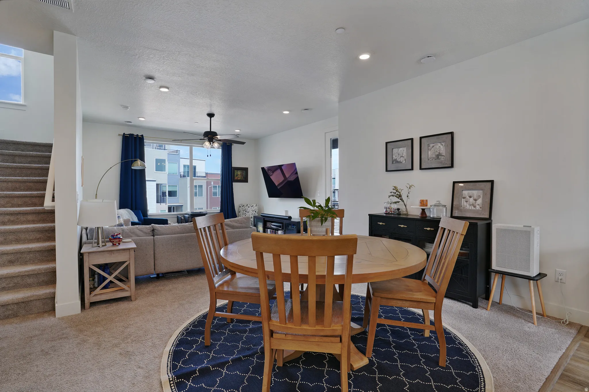 Open-concept living space with recessed lighting and a ceiling fan