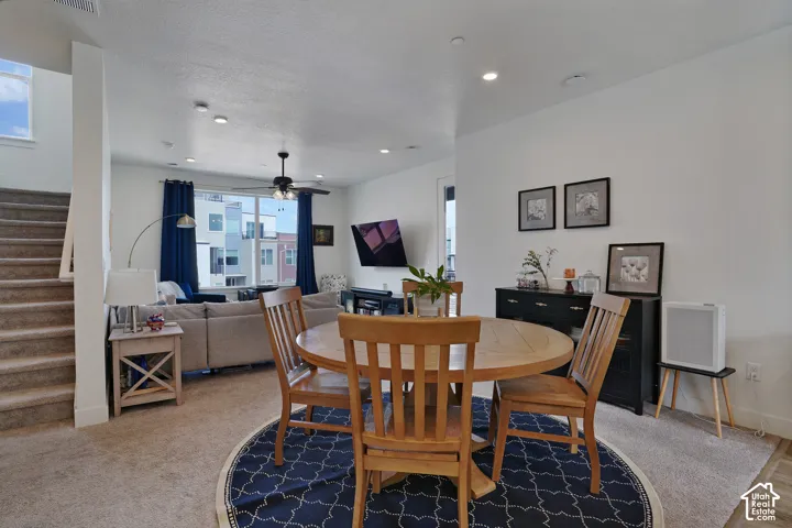 Open-concept living space with recessed lighting and a ceiling fan