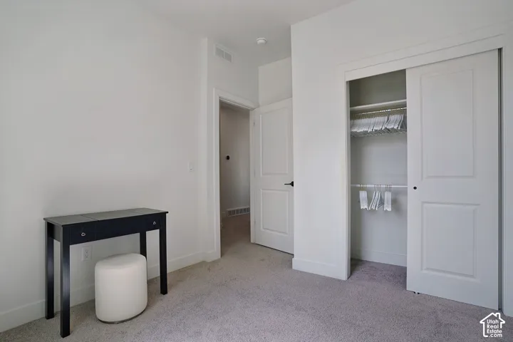 Plush carpeting and a built-in closet with sliding doors