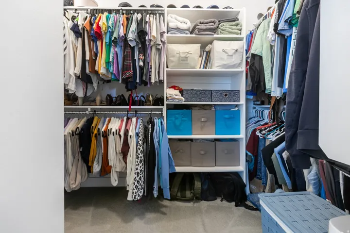 Built-in closet system with multiple shelving units and hanging rods