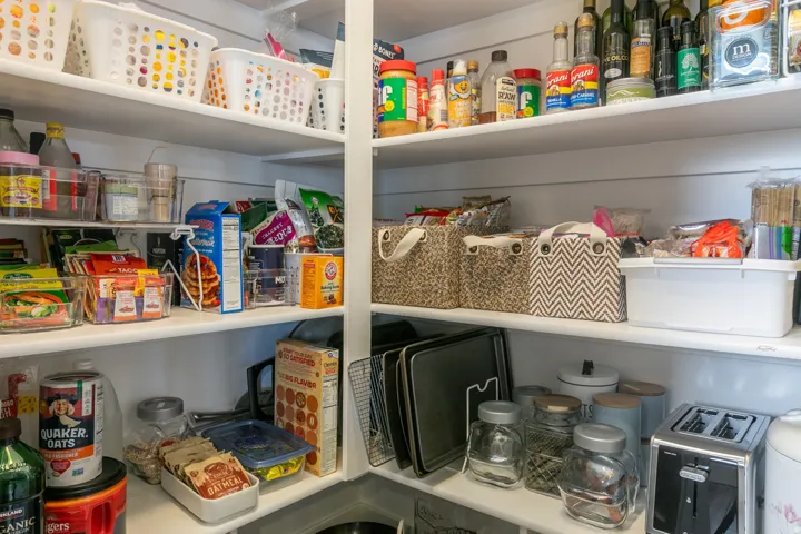 Built-in pantry shelving featuring ample storage space