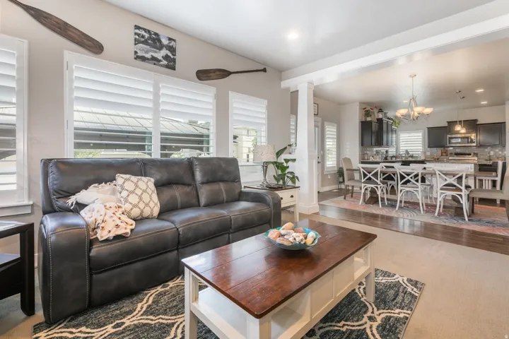 Living area with vaulted ceiling and extensive plantation shutters