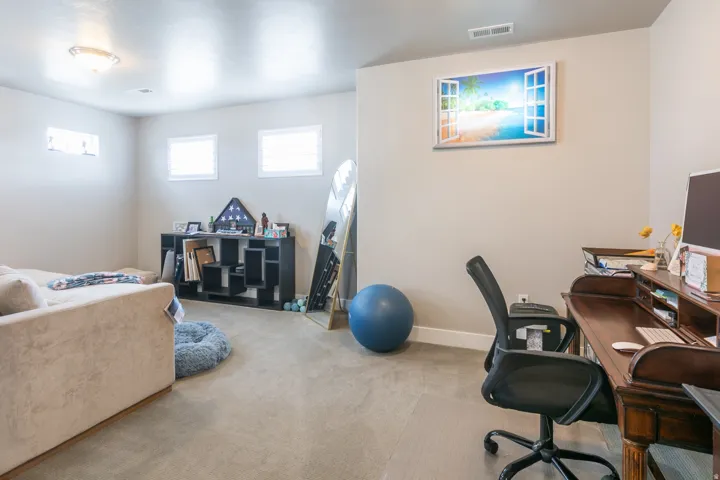 Carpeted flooring, recessed lighting, and multiple windows create a bright interior