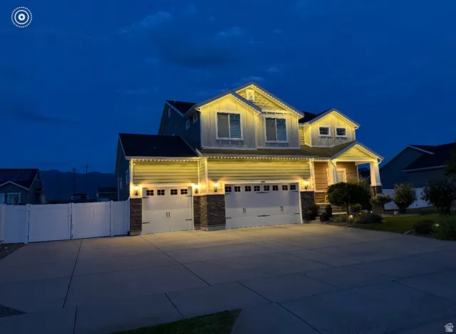 Two-story residence with a two-car garage, stone accents, and a covered front entry
