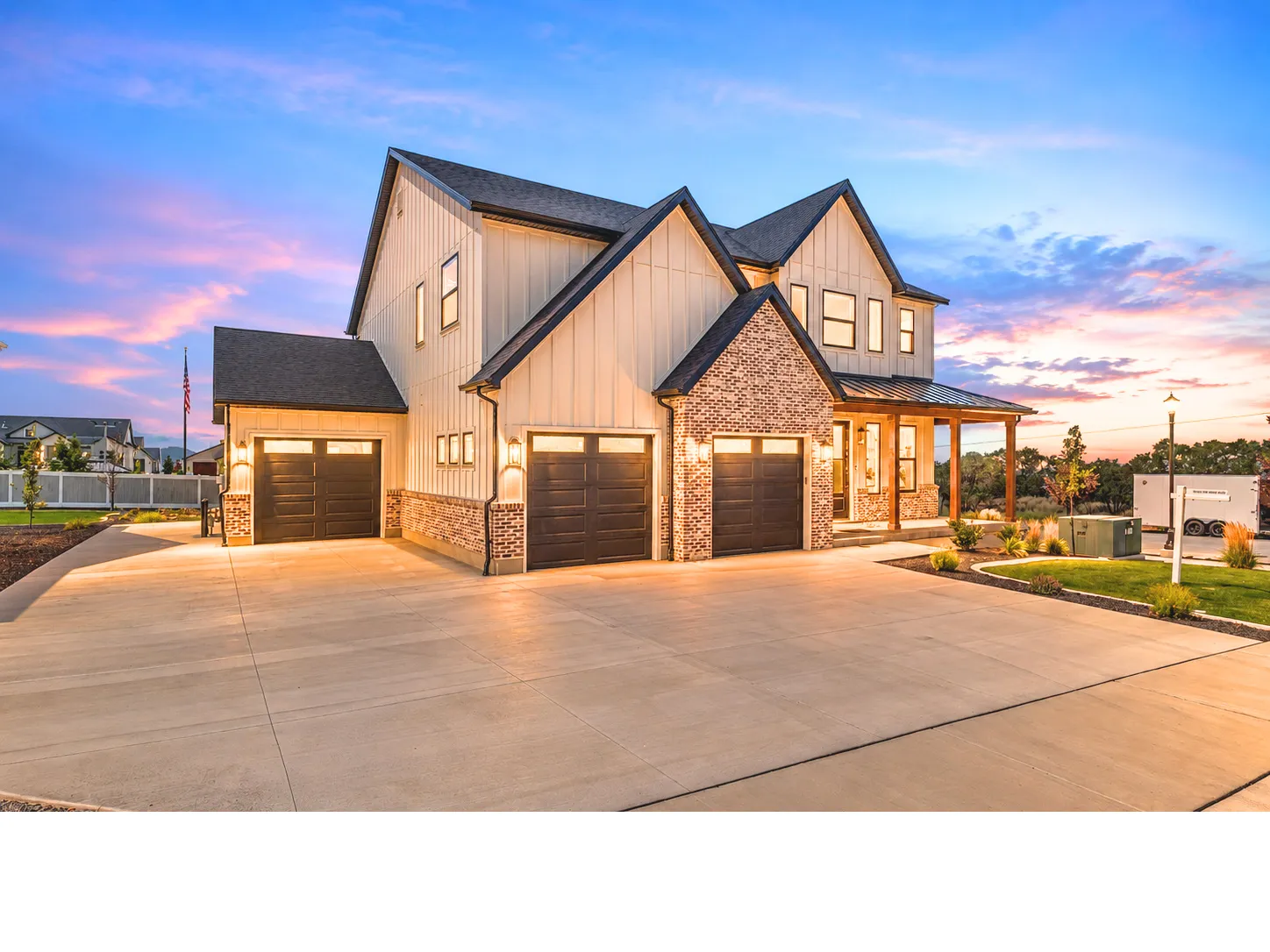 Modern farmhouse exterior with board and batten siding, brick accents, and a covered porch