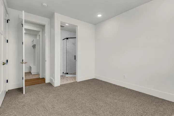 White walls, recessed lighting, and grey carpet flooring