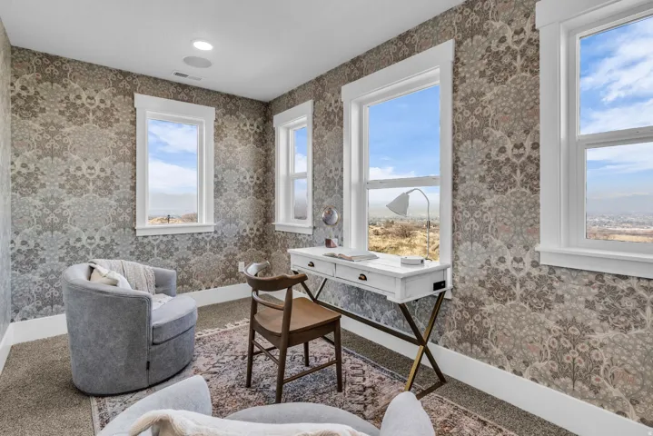 Patterned wallpaper, recessed lighting, and multiple windows