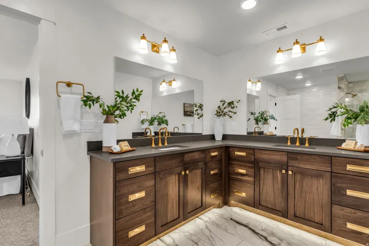 Dual vanity with dark wood cabinetry and gold-tone hardware
