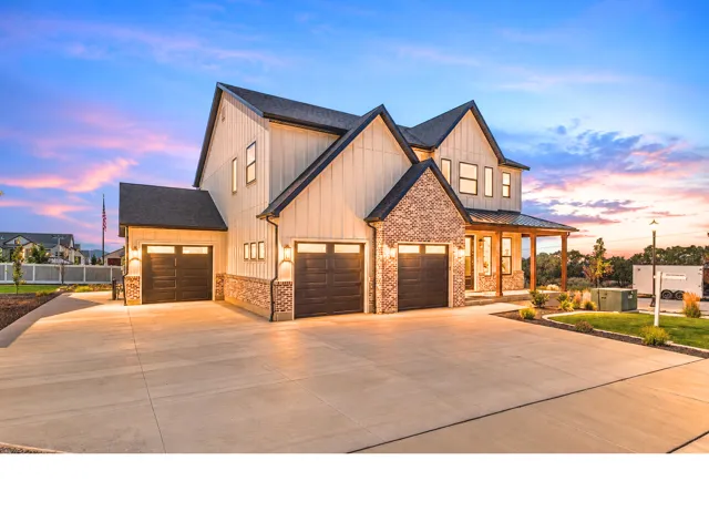 Modern farmhouse exterior with board and batten siding, brick accents, and a covered porch