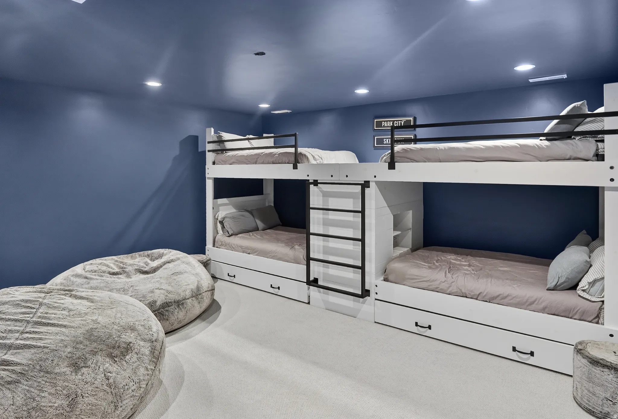 Built-in bunk beds with integrated storage drawers and recessed lighting