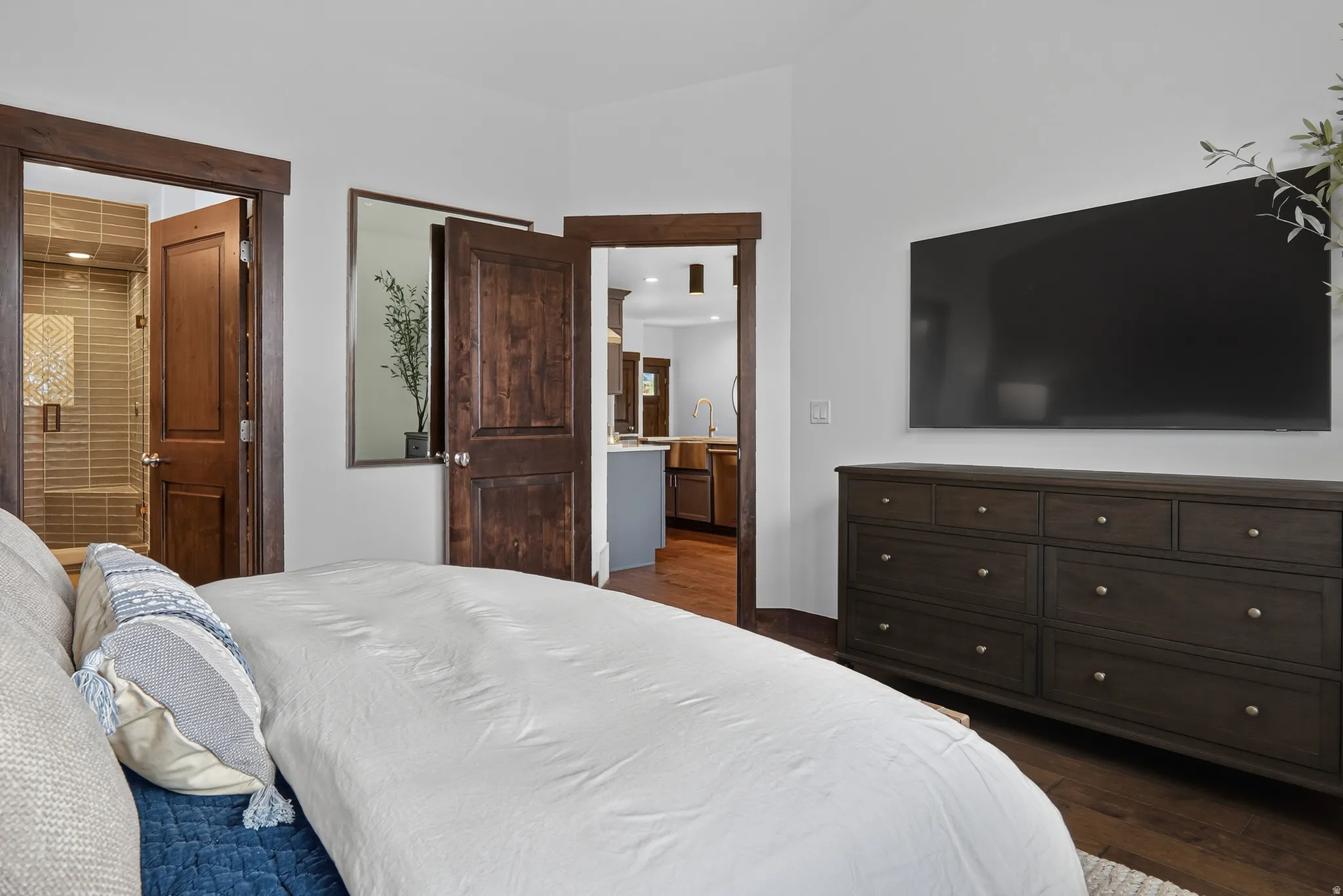 Wood-finish flooring, white walls, and dark wood trim