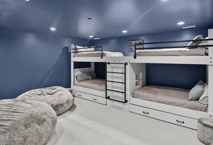 Built-in bunk beds with integrated storage drawers and recessed lighting