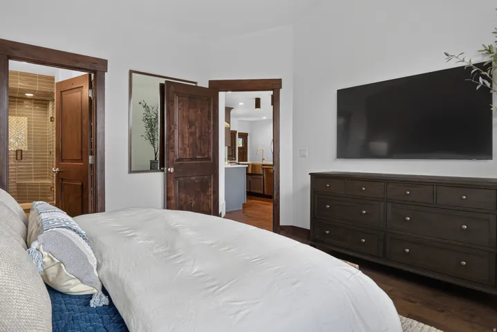 Wood-finish flooring, white walls, and dark wood trim