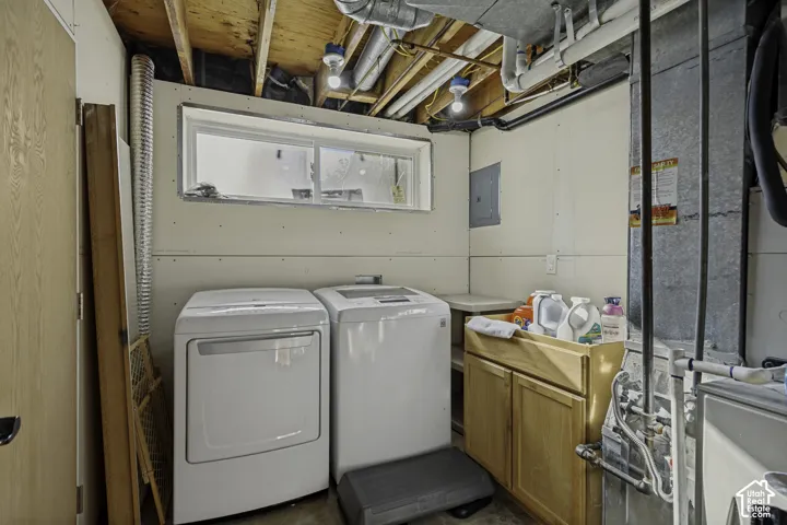 Utility area with a built-in wood-finish cabinet and an exposed ceiling