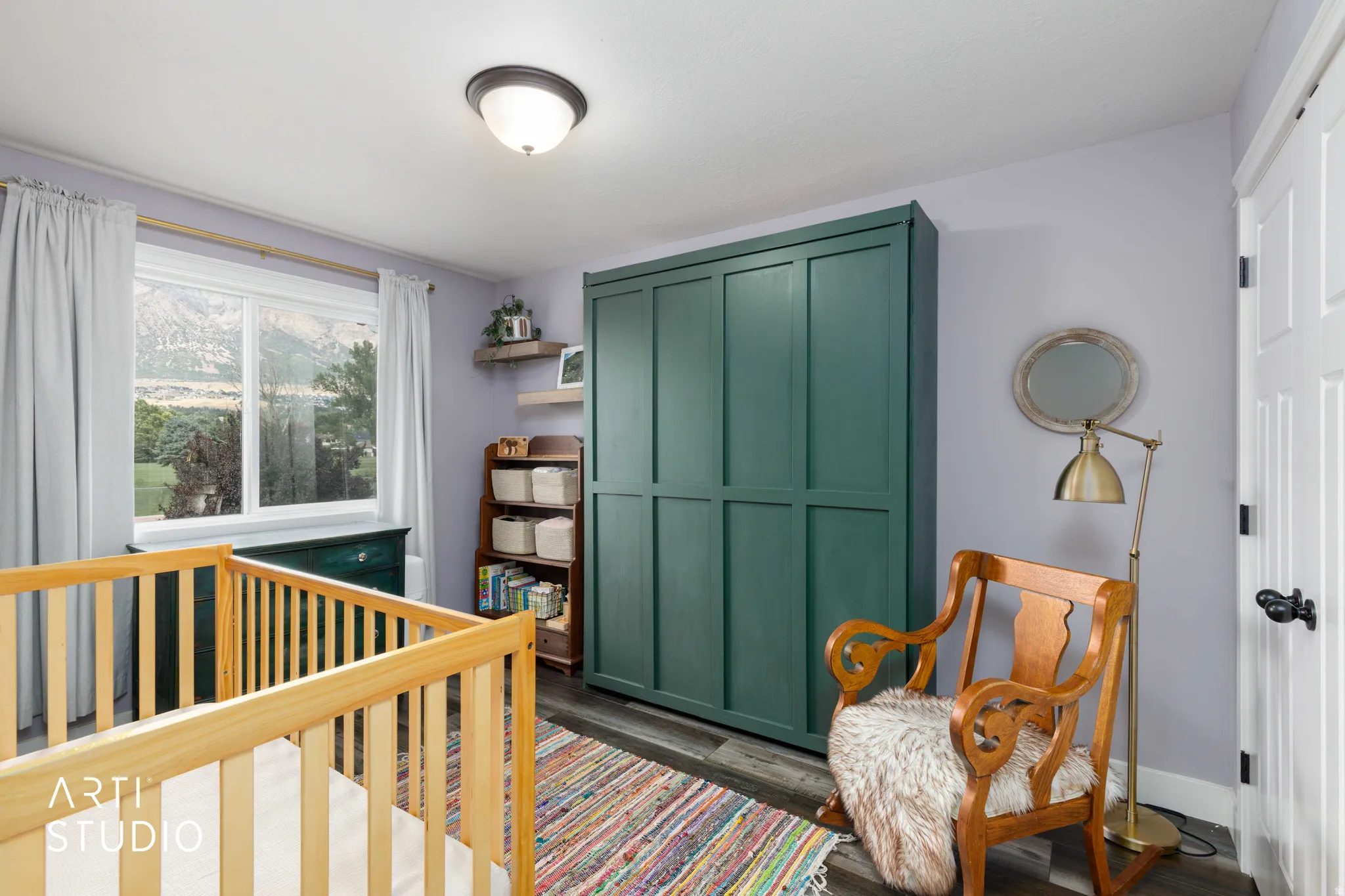 Built-in wardrobe, wood-finish flooring, flush mount ceiling light, and white interior door with black hardware