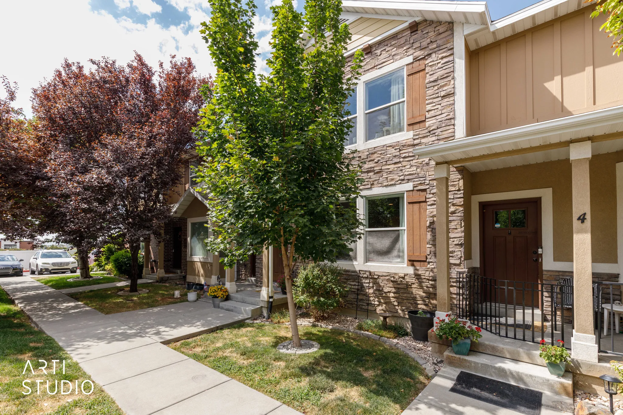 Stone veneer exterior with decorative window shutters and a covered entry