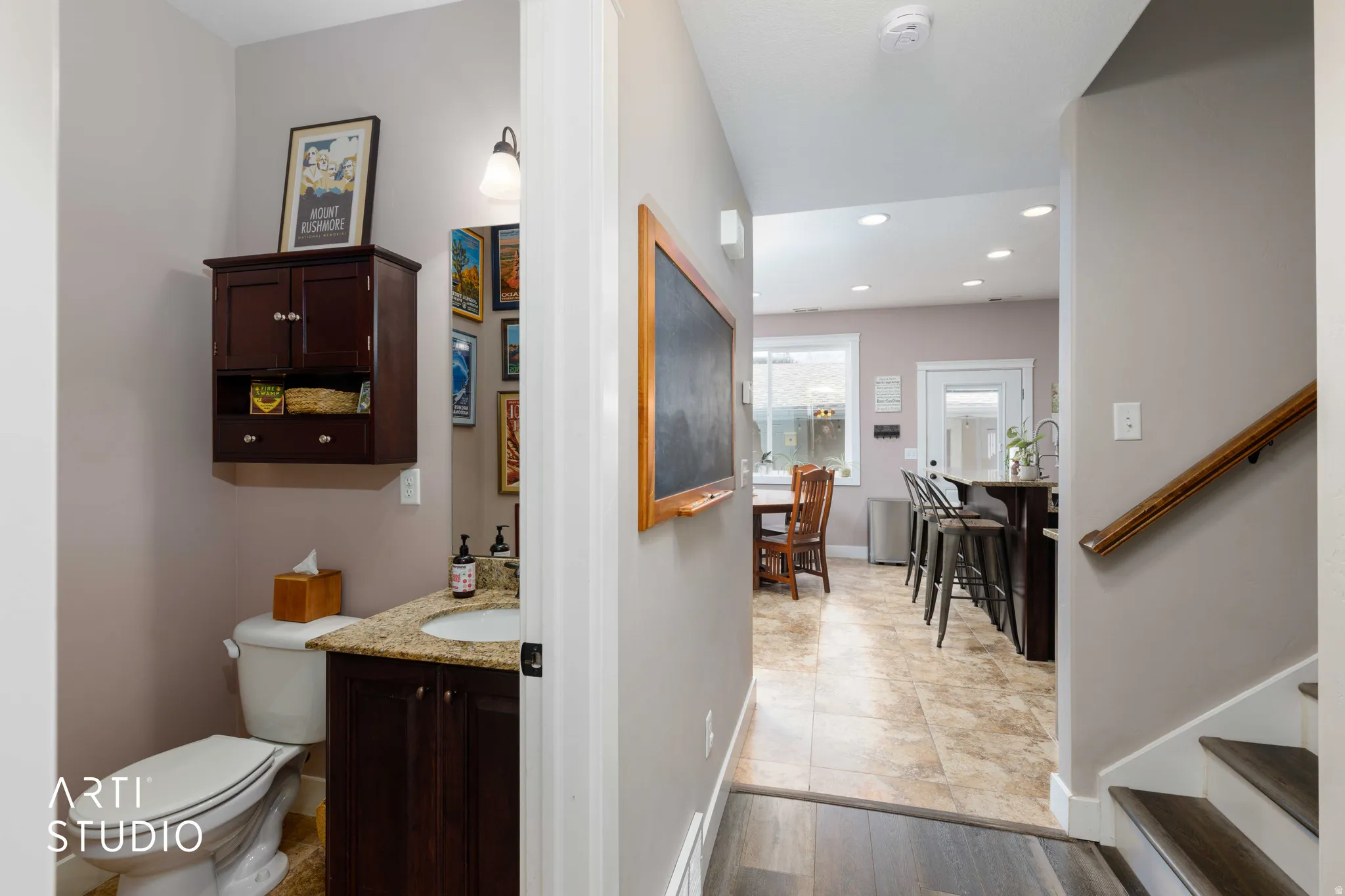 Powder room with vanity and wall-mounted storage cabinet